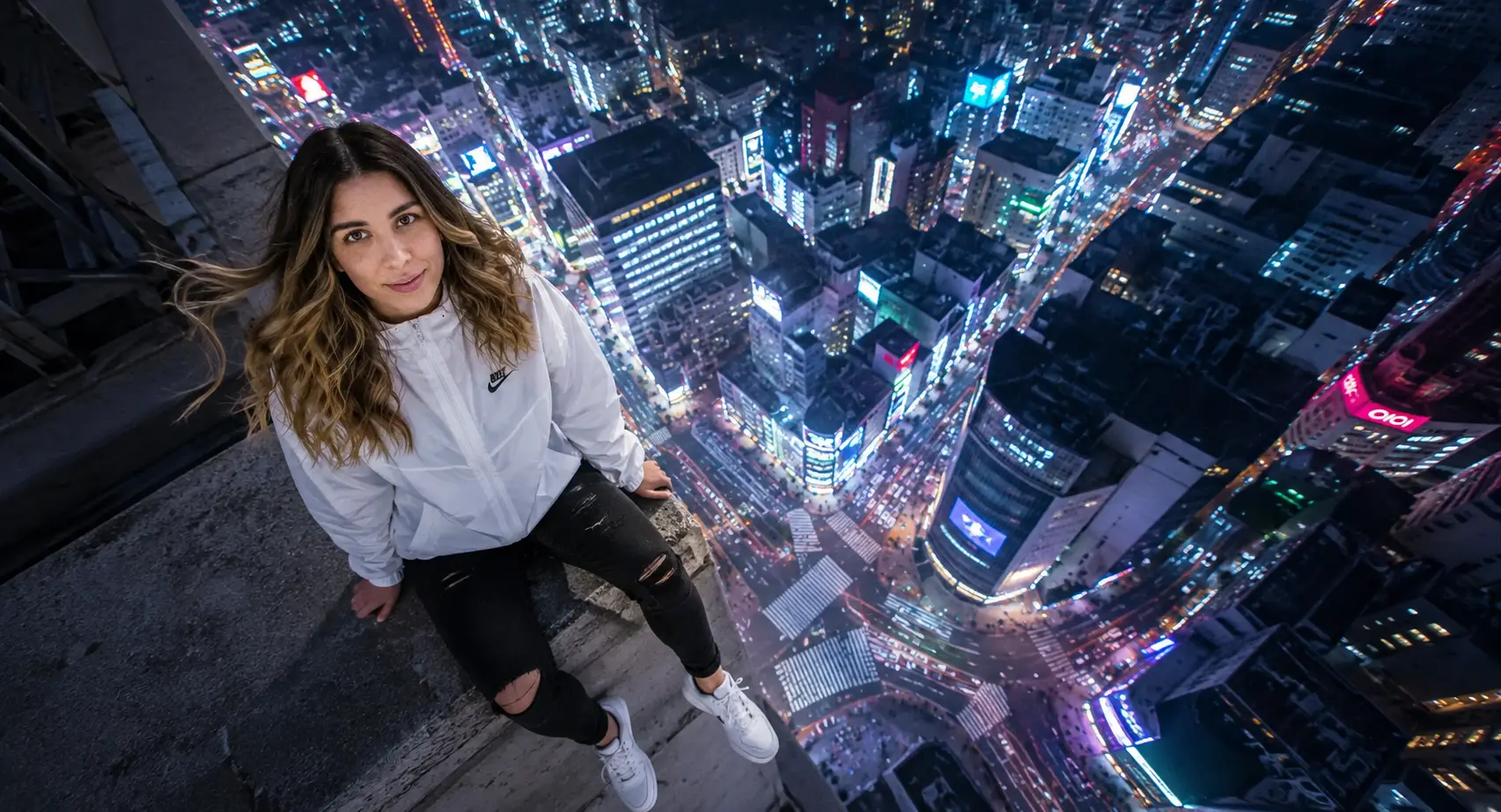 Cool night tones with vibrant city neon reflections.